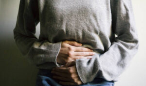 Woman suffering from stomach ache